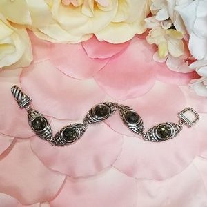 Cute silver toned bracelet with blackish stones.
